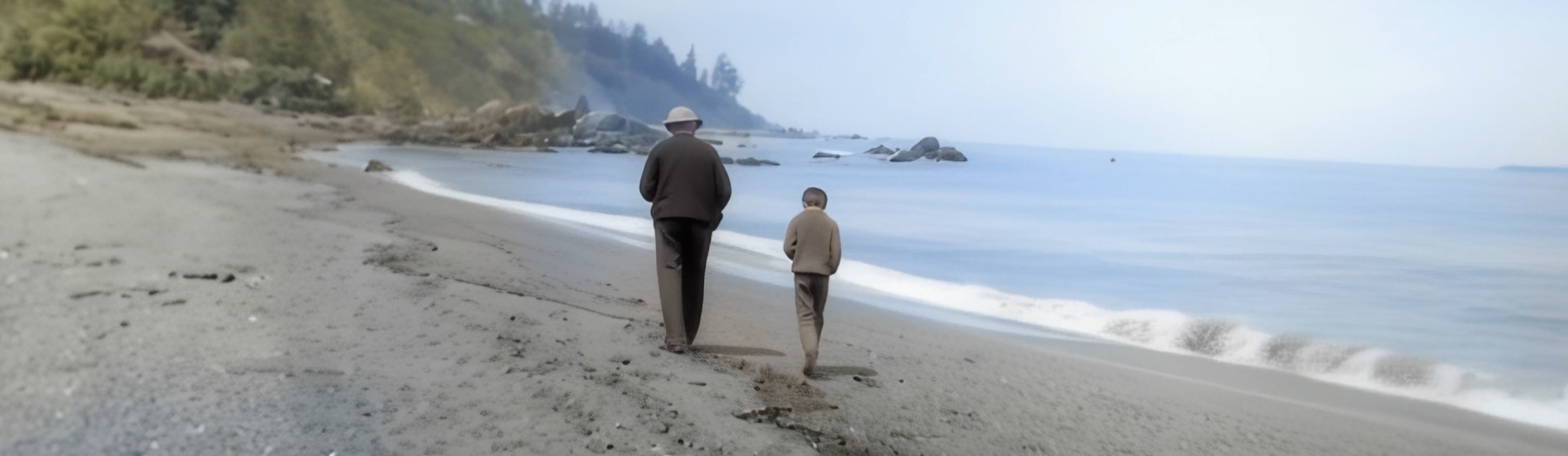 Two people walking together along a quiet beach